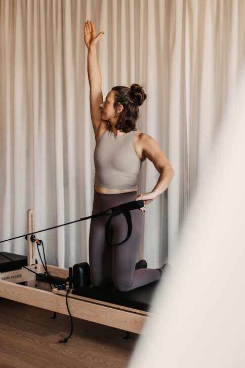 Eine Frau beim Reformer Pilates im Sporthotel Alpina Alpendorf.