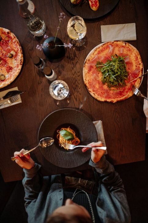 Ein Paar geniessen die Steinofenpizza vom BistrO Pizzeria.